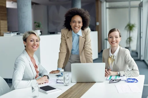 three smiling businesswomen